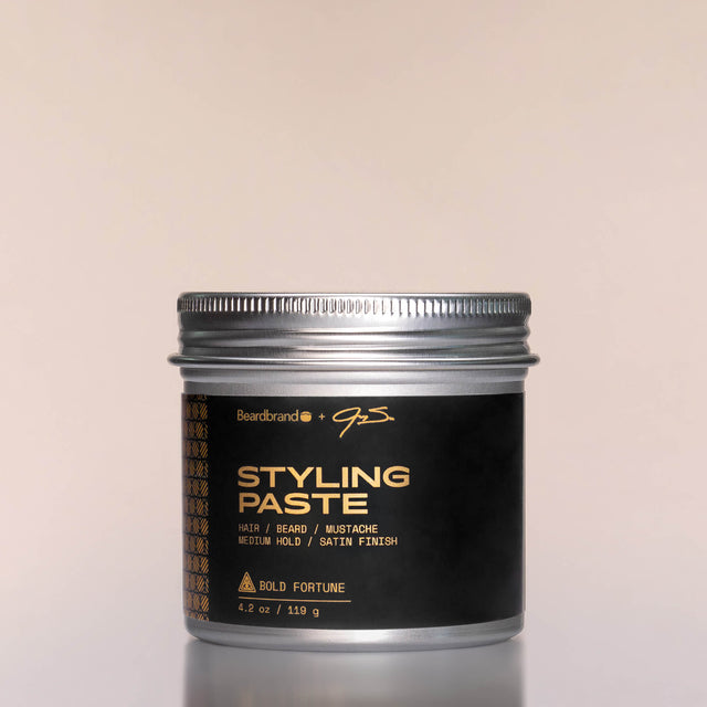 A container of Bold Fortune Styling Paste against a neutral background.