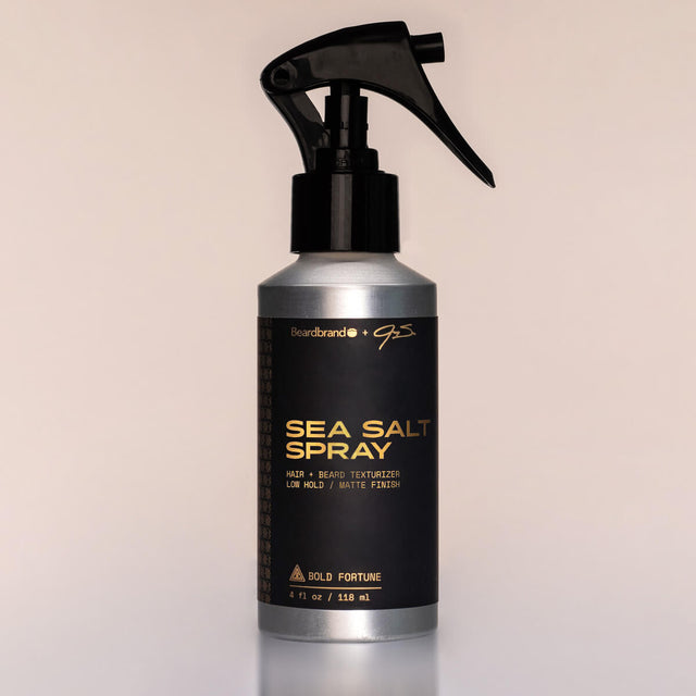 A bottle of special-edition Bold Fortune Sea Salt Spray with a sprayer dispenser against a neutral background.