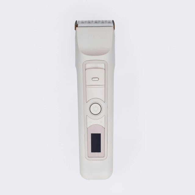 The Beardbrand Utility Trimmer with a sleek design. It features a metal trimming head, a power button, and a small digital display on its body.