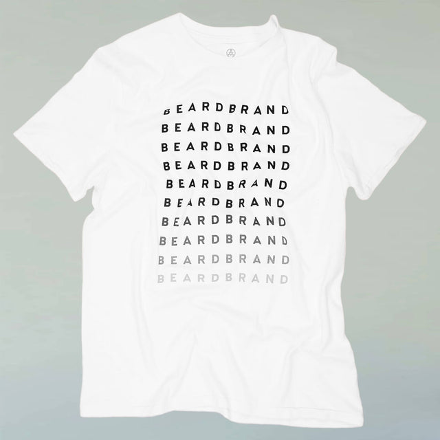 A white Beardbrand Forever Tee with "Beardbrand" in black ink at top repeated until fades to light gray on the front.