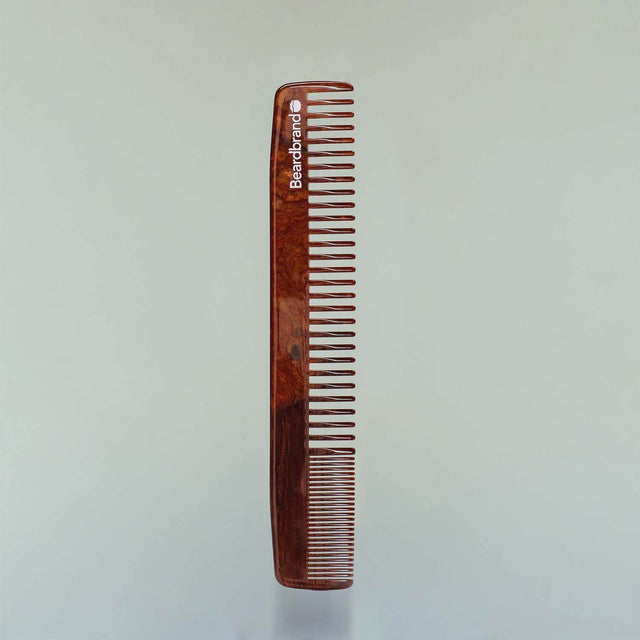 A Beardbrand Large Comb in “Whiskey River” acetate against a grey background.