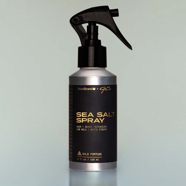 A bottle of Bold Fortune Sea Salt Spray with a sprayer dispenser against a grey background.